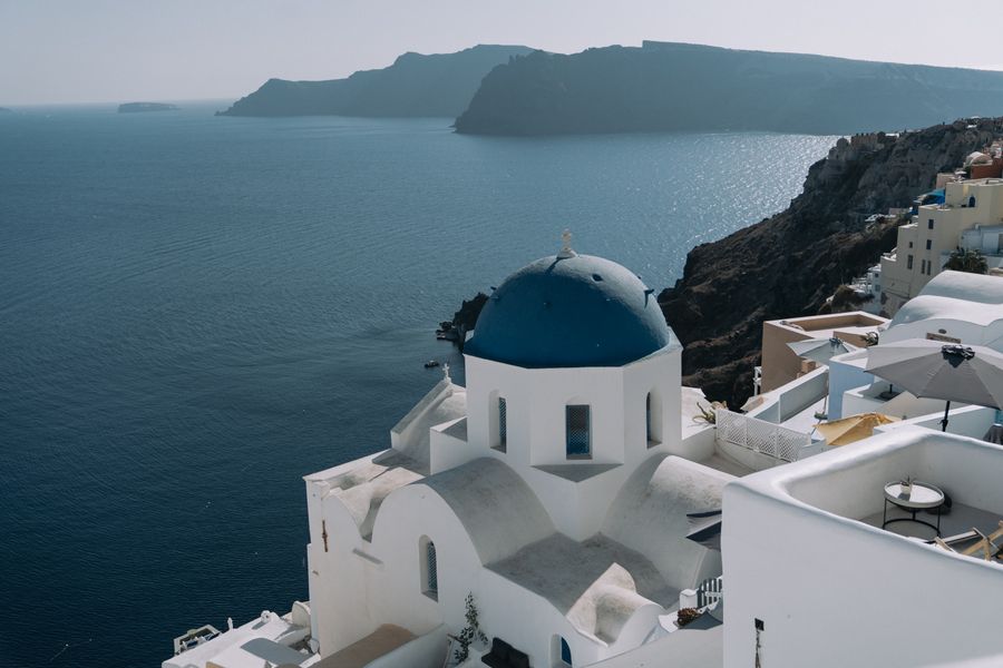white concrete buildings near the sea — Island time, online time: ferries, beaches and full signal.