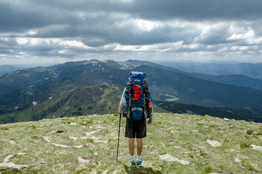 a man standing on top of the mountain