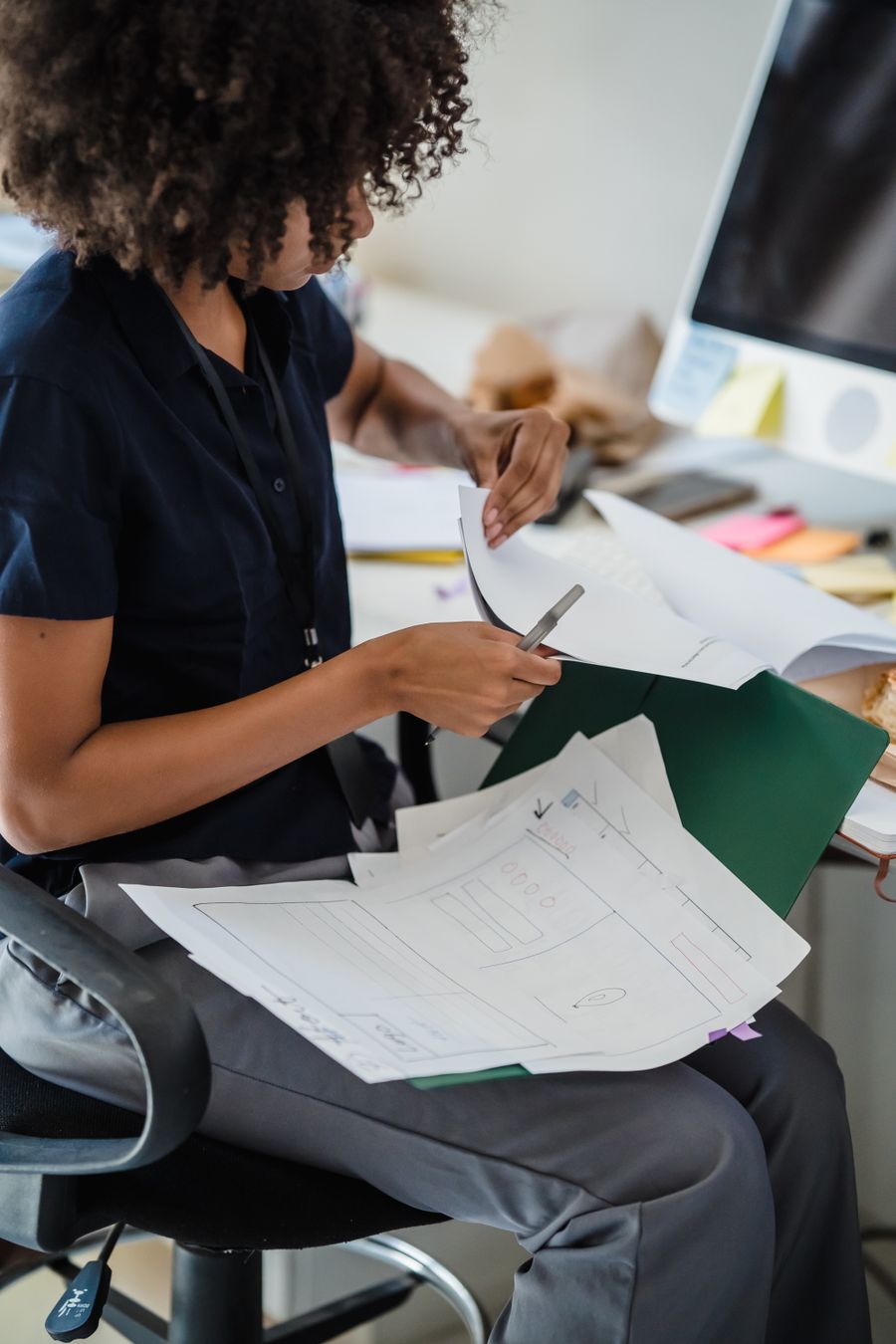 woman working with documents in office — Validated inputs, trip-aware math, plain words — the tool's whole method.