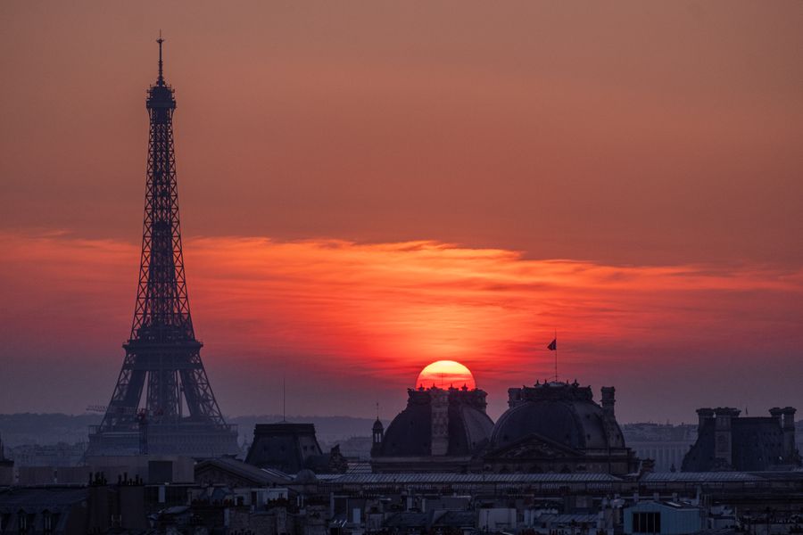 silhouetted eiffel tower at sunset — Souvenir hunting with live currency conversion in your pocket.