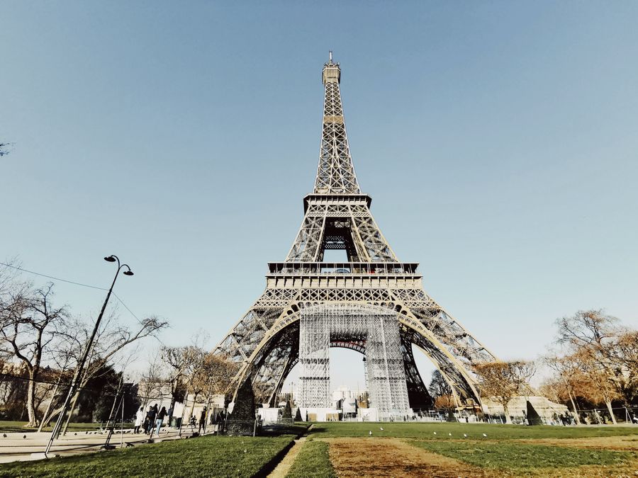 low angle shot of the eiffel tower against blue sky — Dialing Helper: one question, answered well, instead of ten open tabs.