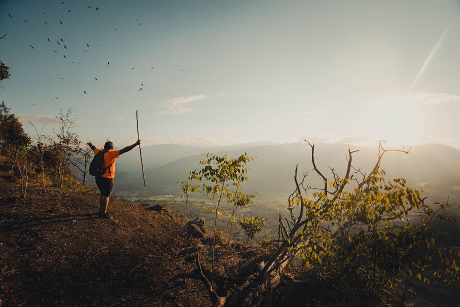 hiker expressing satisfaction after climbing a mountain — Downtown, connected: the eSIM finds the fastest local network on its own.