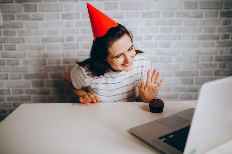 woman with red cap talking on laptop