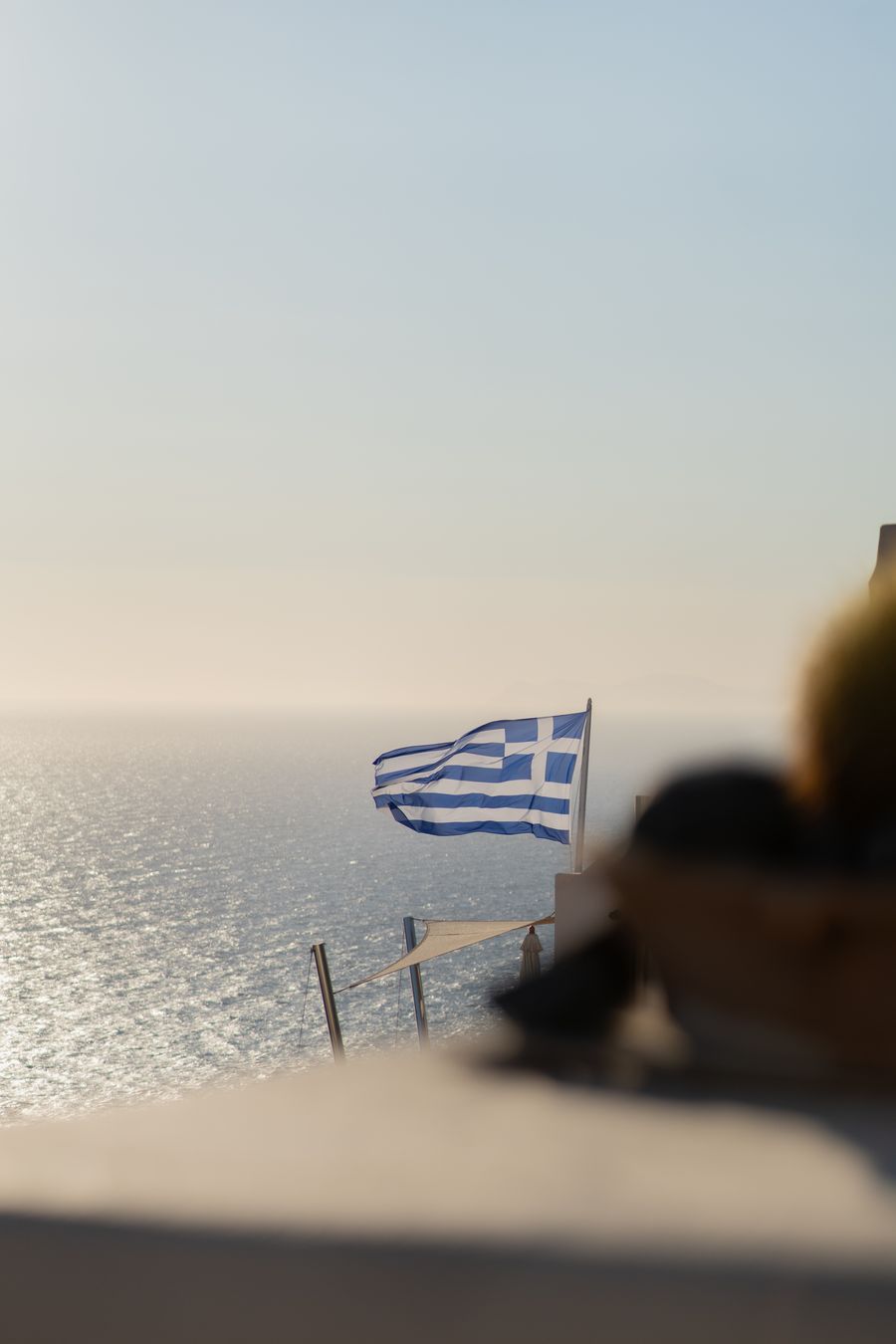 a greek flag is flying over the ocean — From question to next step: Airport Connectivity shortens the path to a decision.