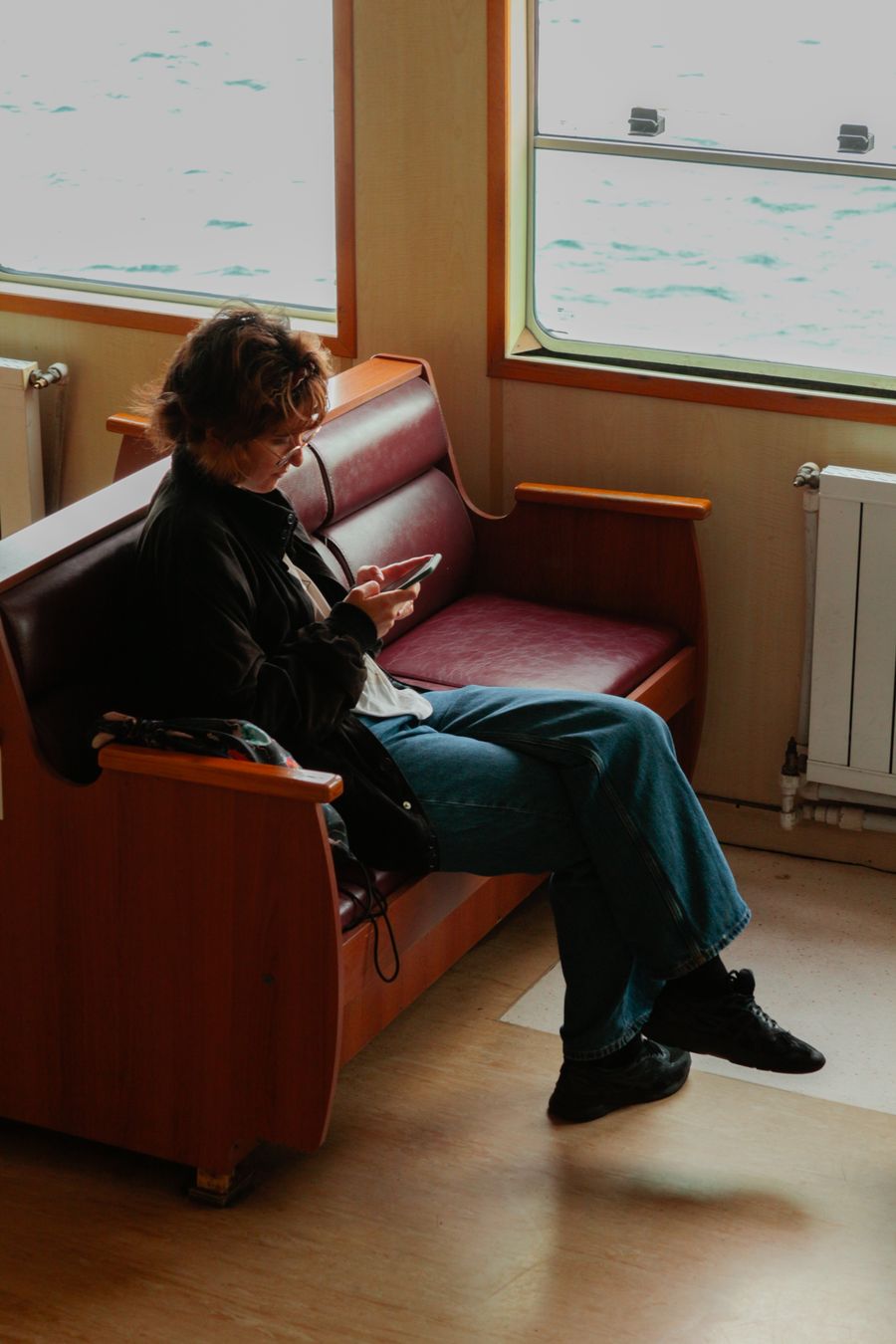 A woman sitting comfortably on a ferry, enjoying a peaceful journey. — From question to next step: Country Connectivity Fact Sheet shortens the path to a decision.