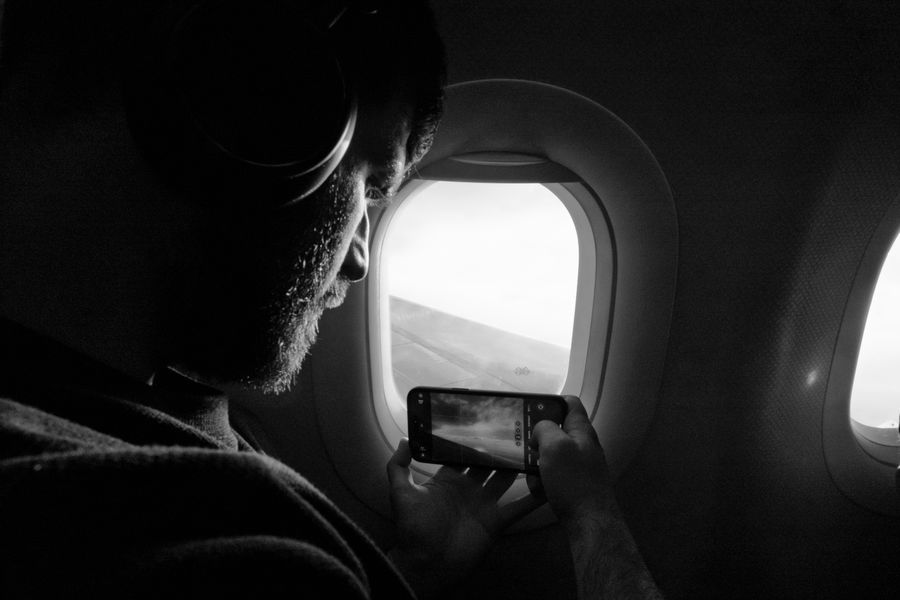 Man taking photo out of airplane window, capturing wing view with smartphone. — The spec grid shows exactly what Captive Portal Detector accepts and what it returns.