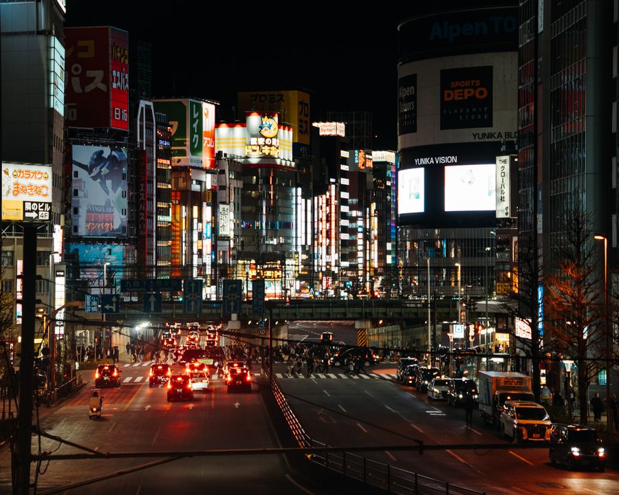 vibrant night cityscape of shinjuku tokyo — Dialing Helper links every answer onward — usually the plan it recommends.