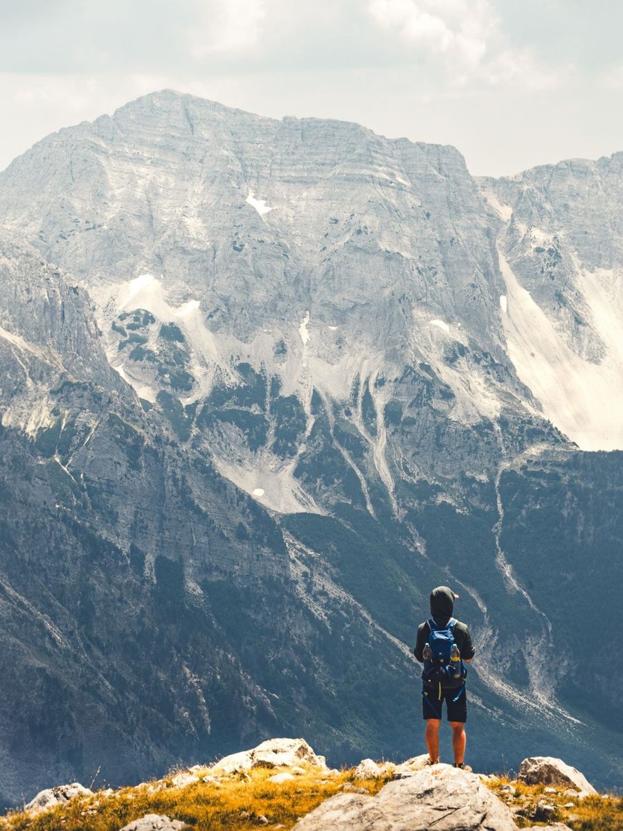 hiker admiring majestic albanian mountains — The FAQ below Coverage Checker answers the six questions everyone asks first.