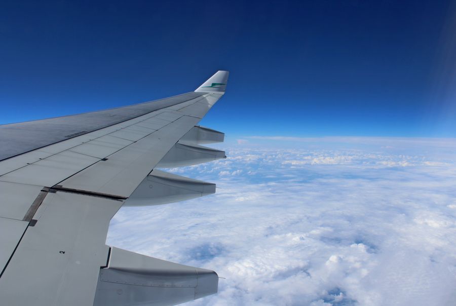 airplane wing above the clouds — The viewpoint at golden hour: livestream the sunset to everyone back home.