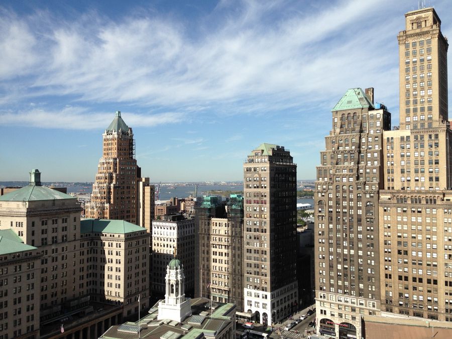 view of brown and grey high rise building — Rooftop-Check-in: Bordkarten und Hotelschlüssel, alles auf dem Handy.