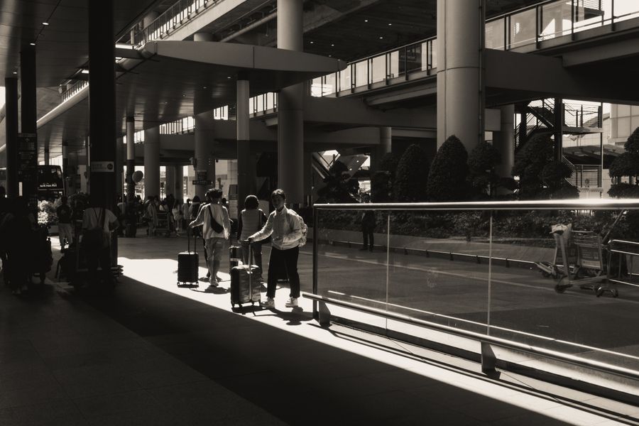 travelers with luggage at modern airport terminal