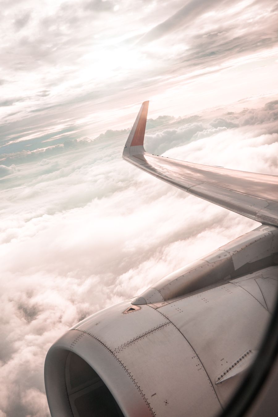 airplane over white clouds — The window seat office: emails sent somewhere over the ocean.