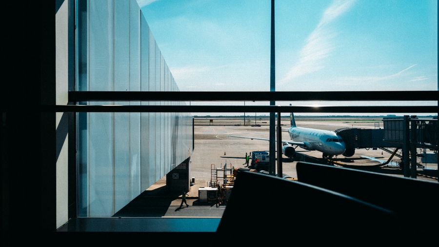 bright airport terminal with docked airplane view — From Country Connectivity Fact Sheet's answer to checkout is a short, well-lit path.