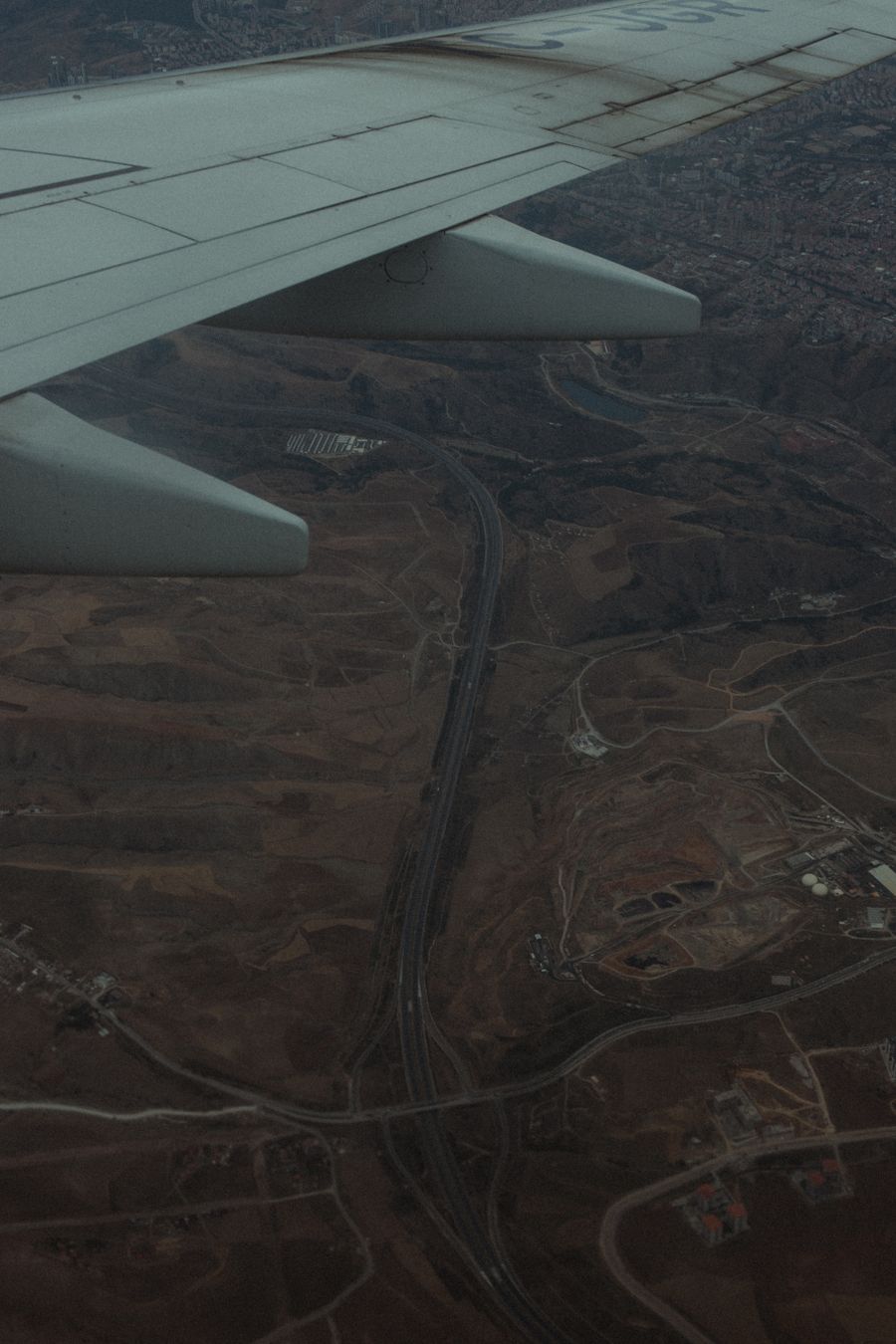 aerial view from airplane over barren landscape — Data Usage Estimator: tell it about the trip, get the answer in under a minute.