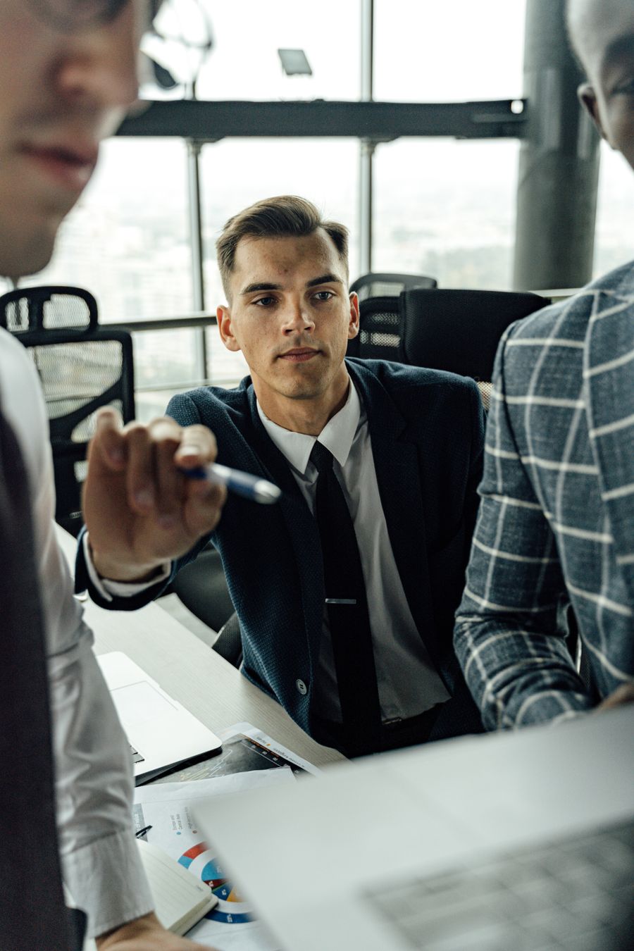 man in black suit pointing a pen — Best Network by City remembers, so repeat travelers barely type.