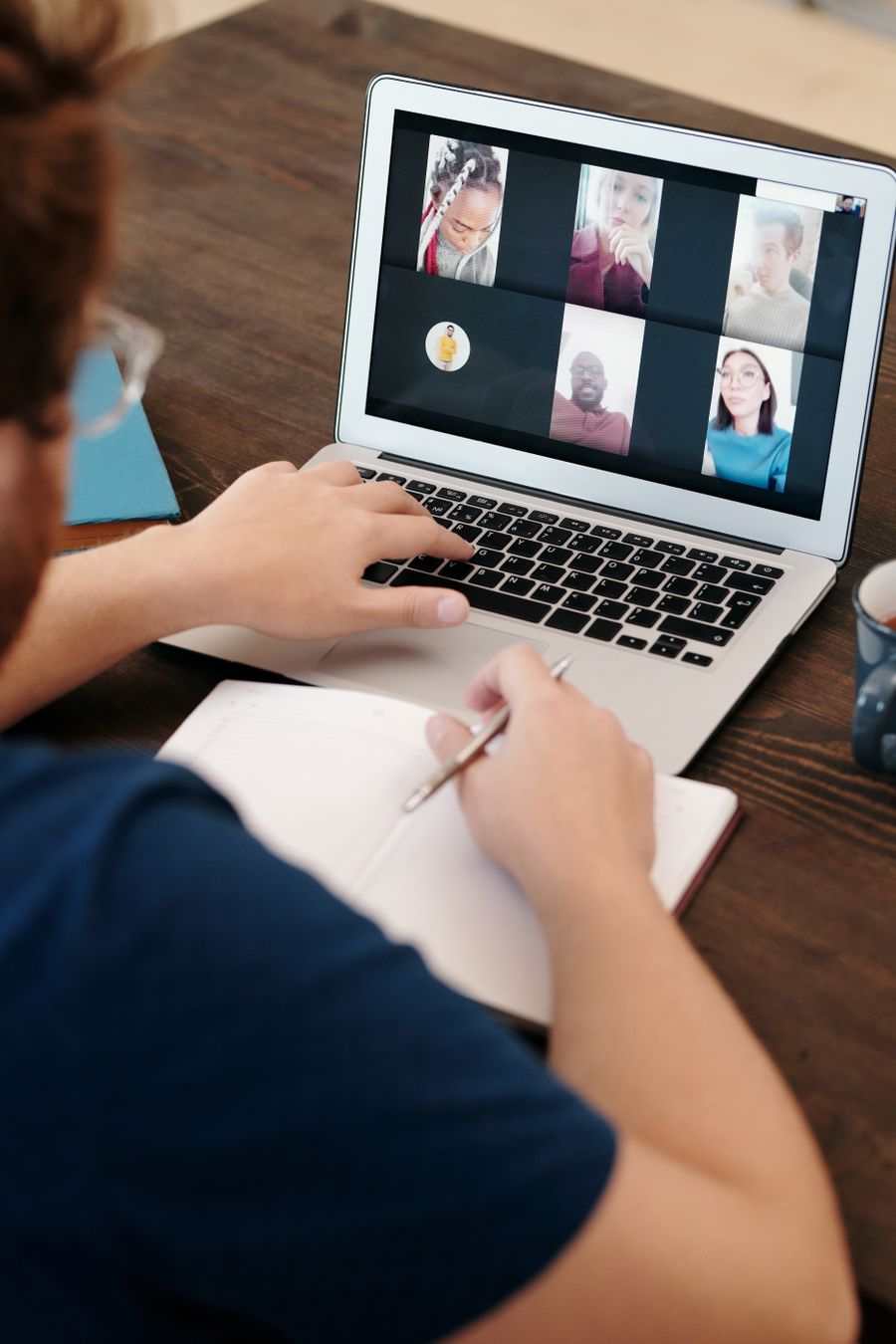 man in blue shirt having a virtual meeting — Airport Connectivity: tell it about the trip, get the answer in under a minute.