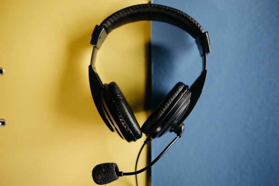 black corded headphones on blue and yellow surface