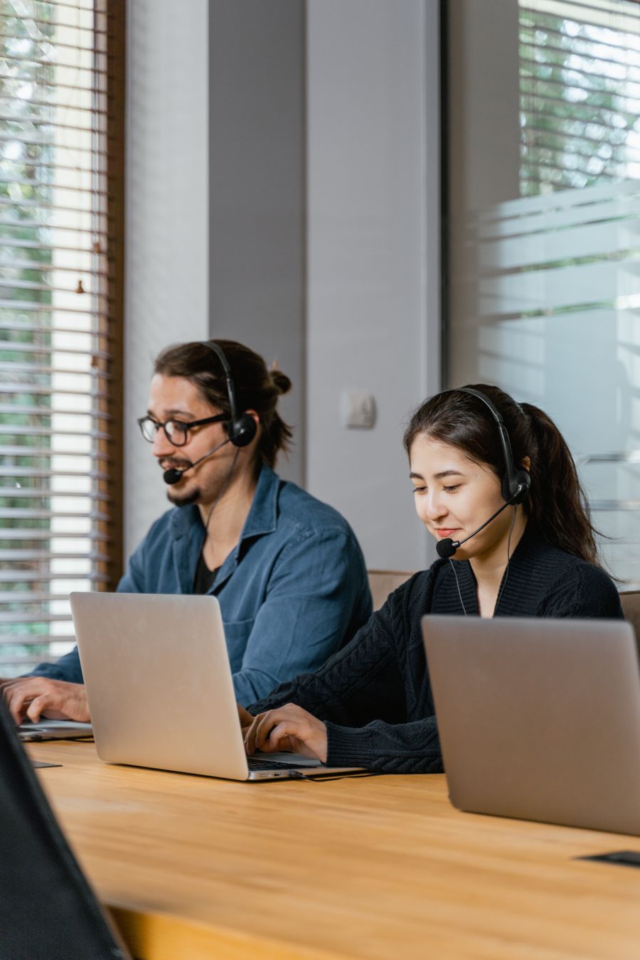 photo of a man in a blue shirt working beside a woman in a black top — The capability matrix lists everything this tool does — no asterisks.