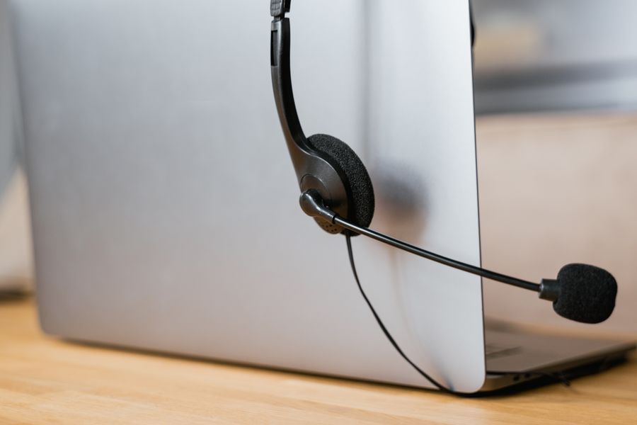 close up shot of headphones hanging on a laptop — The capability matrix lists everything What’s My IP? does — no asterisks.