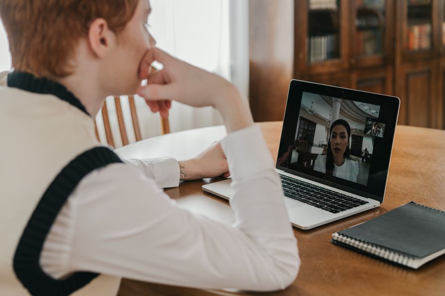 a man having a video call on his laptop — How Much Speed Do You Need? remembers, so repeat travelers barely type.