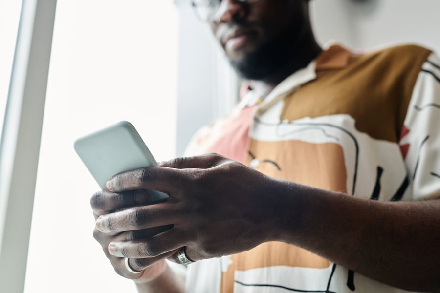 close up shot of a man using a smartphone