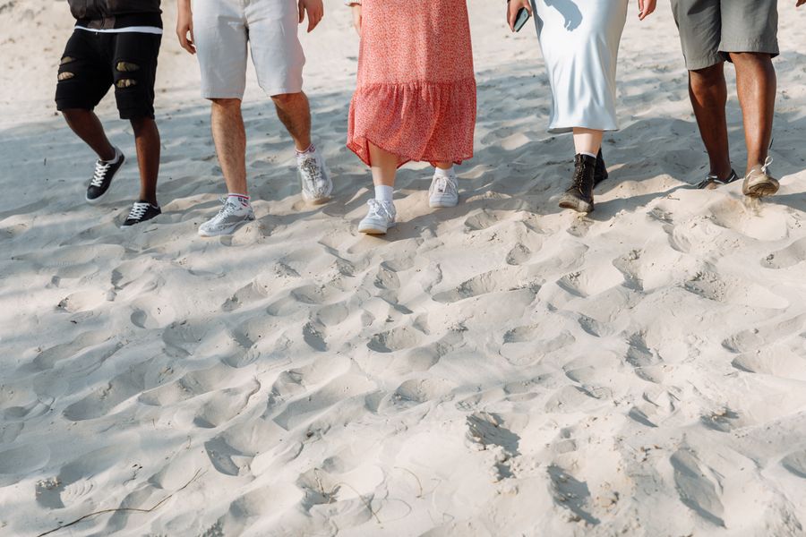 people walking on the sand