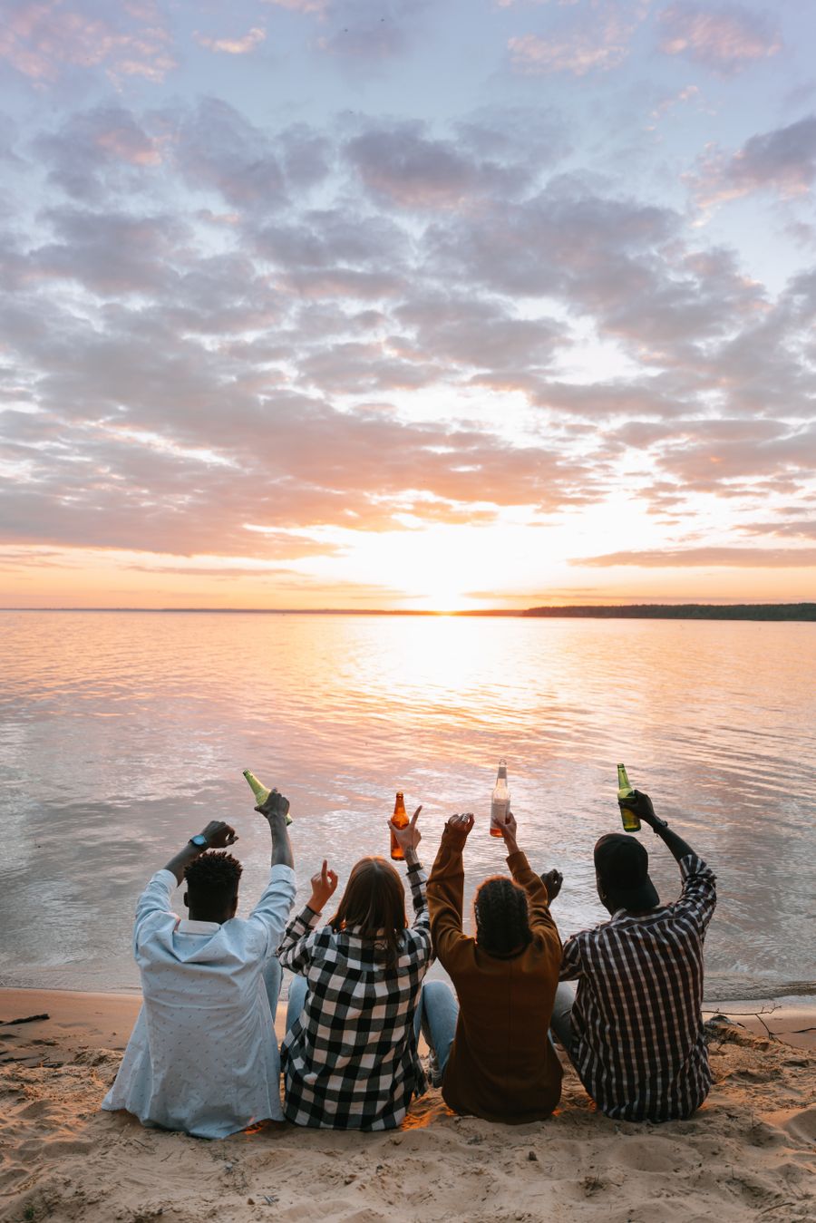 people sitting on beach during sunset